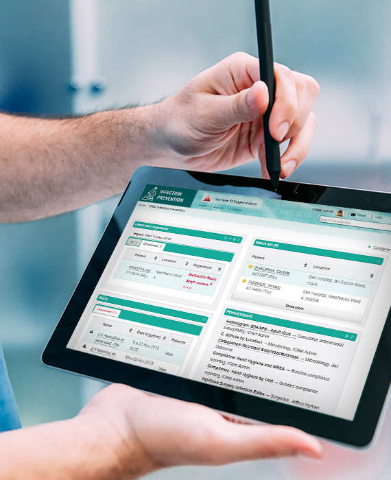 Male nurse using stylus to point to tablet displaying ICNET software