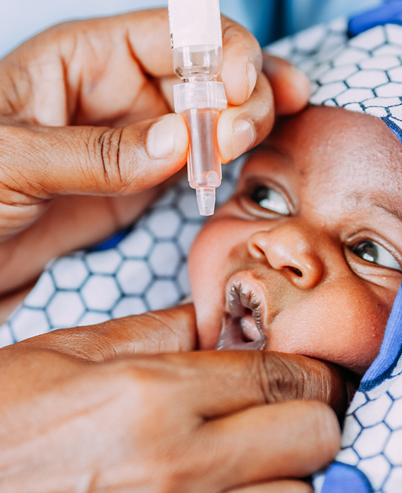 African baby receiving oral vaccine