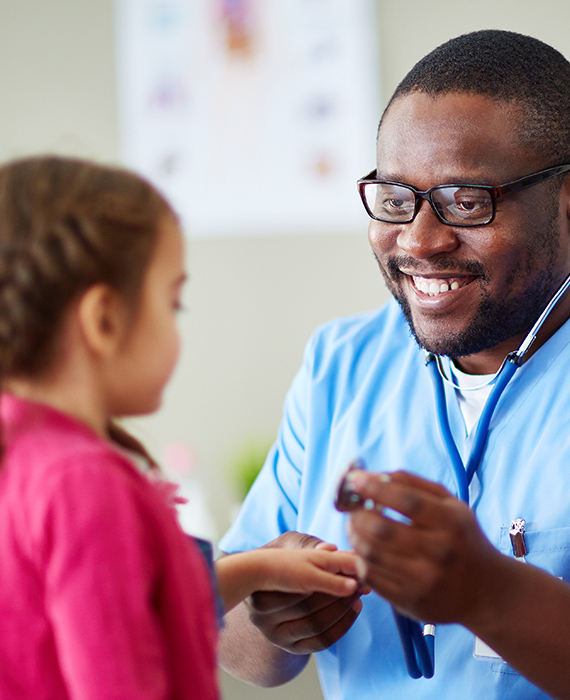 Male nurse using stethoscope on patient.